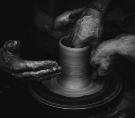 Hands working on pottery wheel