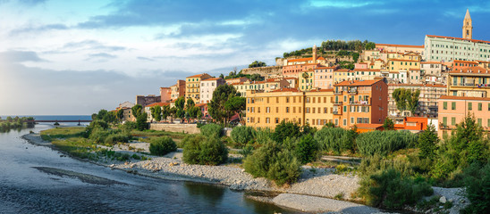 Colorful houses under blue sky in old town of Ventimiglia, Italy.