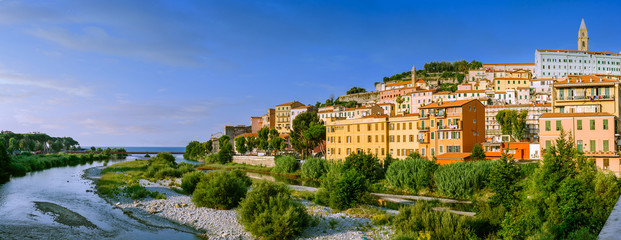 Colorful houses under blue sky in old town of Ventimiglia, Italy.