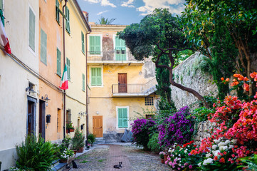 Fototapeta na wymiar The yard with many flowers in the ancient town of Ventimiglia. Italy.
