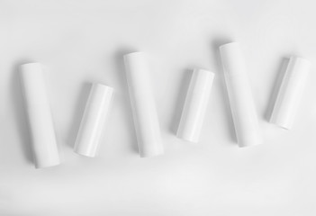 Blank cosmetic tubes on white background. White and silver color