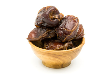 Dried dates fruit in a wooden bowl