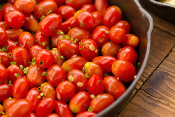 Stir fried sweet tomato cherry on pan.