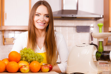 Woman in kitchen preparing fruits for juicing