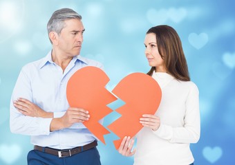 Sad couple holding broken heart
