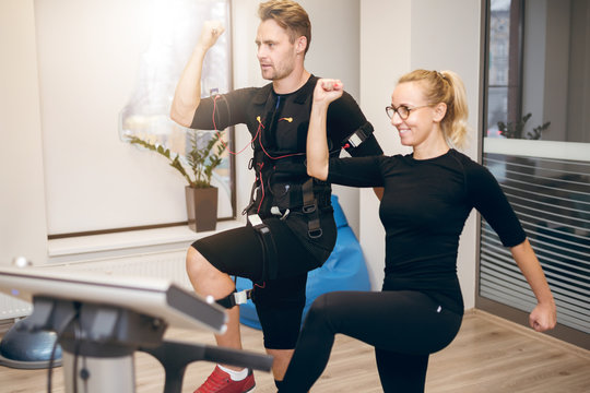Sportsman doing ems training with personal trainer