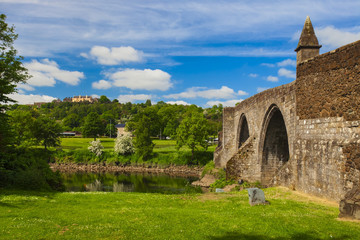 StirlingoOld bridge with arches, turrets and buttresses crosses the Forth river. Scotland,