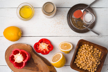 Ingredients for hummus preparation ob the white wooden table top view