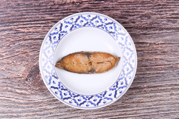 Deep-fried dried salted spotted mackerels in Thai pattern dish.