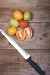 Tomatoes in a natural basket on a rushtic wooden background
