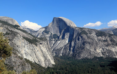 Fototapeta na wymiar In view are North Dome, Half Dome, and Yosemite Valley. Photographed looking east from the Upper Yosemite Fall Trail, Yosemite National Park, California.