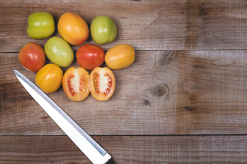 Tomatoes in a natural basket on a rushtic wooden background