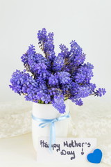 Bluebell flowers in vase and happy mothers day note