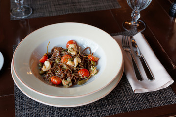 Rye pasta with capers and prawns