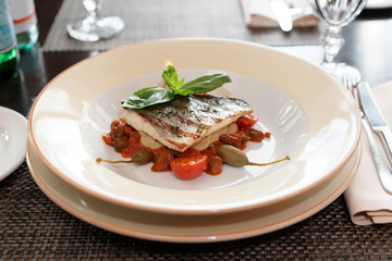 Sea bass fillet with tomato sauce and capers