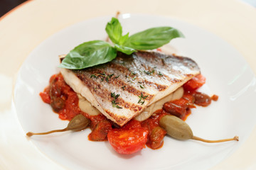 Sea bass fillet with tomato sauce and capers