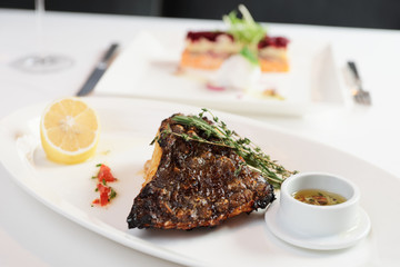 Grilled flounder with lemon and savory sauce