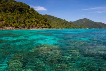 Fototapeta na wymiar A clear water of ocean beside island in Tropicana under clear sky located south of thailand
