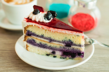 Cream cake with berries on the table layer. Wooden background, banner for confectionery