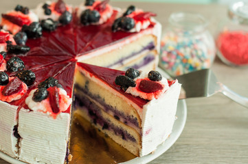 Cream cake with berries on the table layer. Wooden background, banner for confectionery