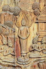 Buddha wooden carving on window in a temple, Thailand.
