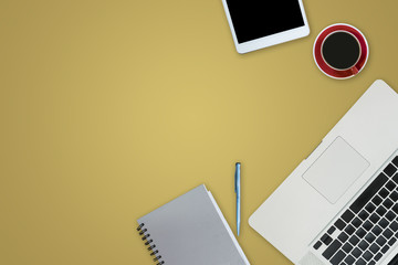 office equipment,laptop computer, smartphone with white screen over a notebook and cup of coffee. Top view on yellow background with copy space, flat lay.