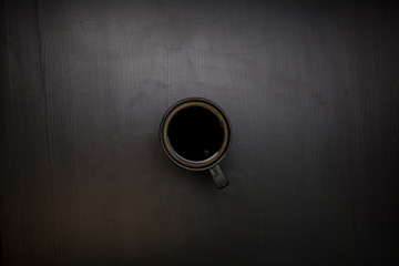 A cup of black coffee. View from above. The invigorating drink.