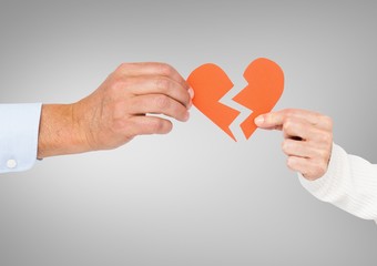 Hands of couple holding a broken heart