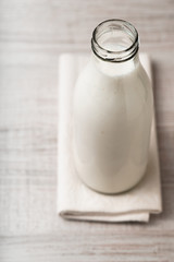 Kefir in a glass bottle on the napkin