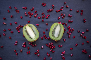 Fresh kiwi halves on a black background