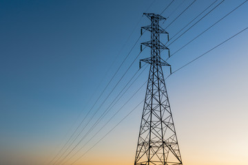 high voltage post.High-voltage tower sunset background.