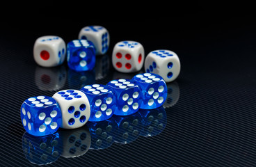 blue and white dices on the glossy black background