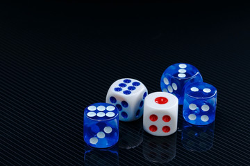 blue and white dices on the glossy black background