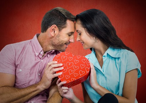Romantic couple holding a gift box
