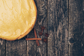 Lemon meringue pie on rustic wooden background.