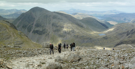 Hiking on Scafell Pike  looking back towards Great Gable, Sty Head Pass and Styhead Tarn in the...