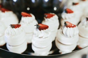 Slices of strawberries put on cream on white cakes