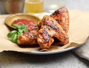 Delicious crispy chicken wings with sauce and beer