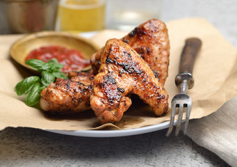 Delicious crispy chicken wings with sauce and beer