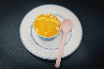 Orange cupcakes in blue baking cup and on the white dish, select focus.