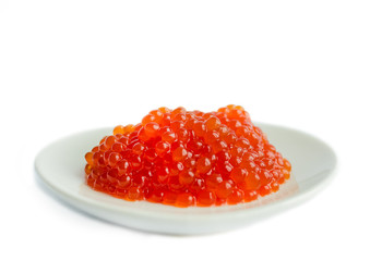 Red caviar on a platte, isolated on white background, close up