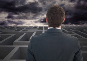 Businessman looking over a maze