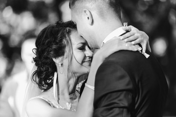 Young bride cries while groom hugs her tender