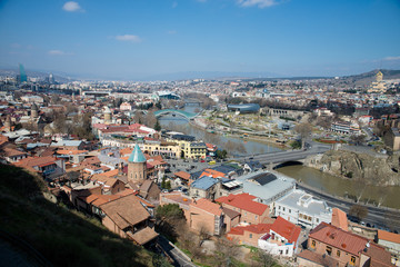 Fototapeta na wymiar TBILISI, GEORGIA - MARCH 5, 2016: Top view of the river and the Church in the central part of the city.