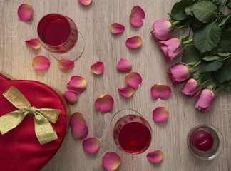 A glass of wine with roses.