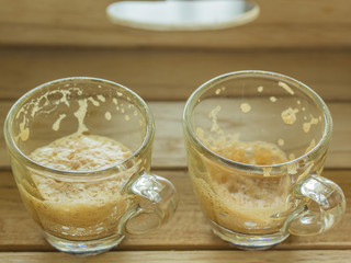 Golden bubble of hot coffee cup placed on a wooden table.