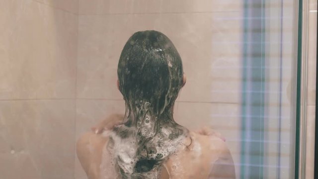 Shower girl wash her hair and head in slowmotion