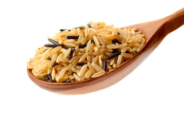 Brown and black rice in wooden spoon on white