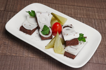 Traditional Russian appetizer to vodka: sandwich with lard and o