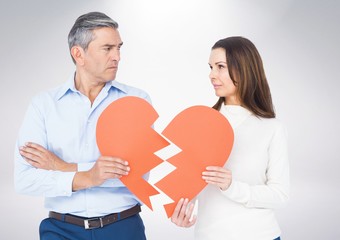 Mature couple holding a broken heart